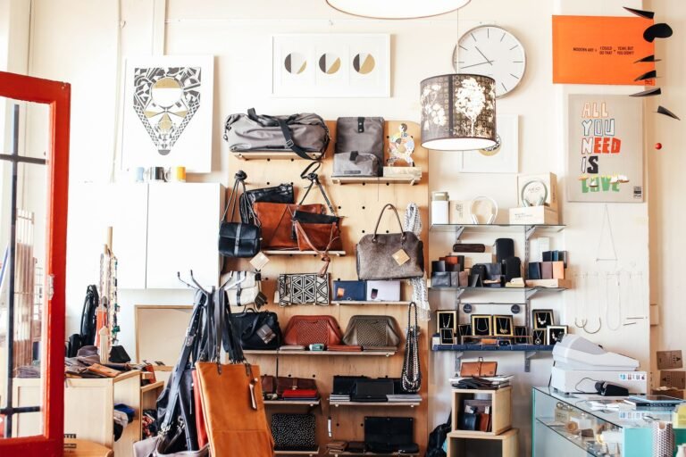 An abundance of stylish bags placed on shelves in a modern light shop