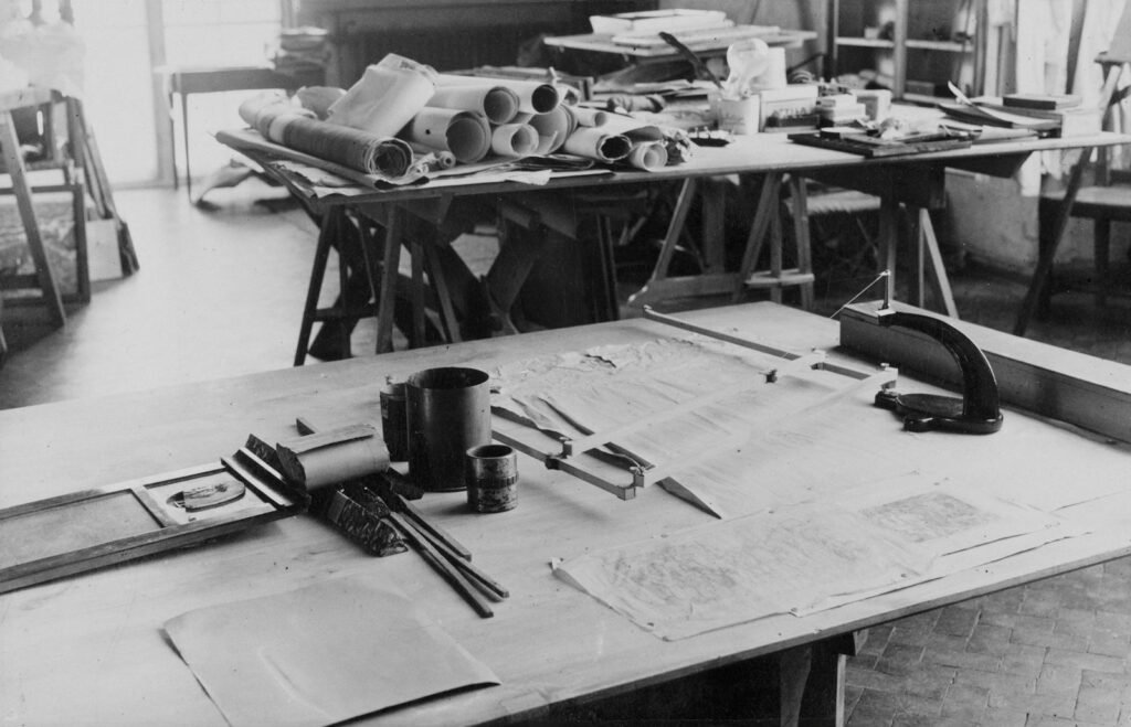 Architectural drafting table with blueprints and drawing tools