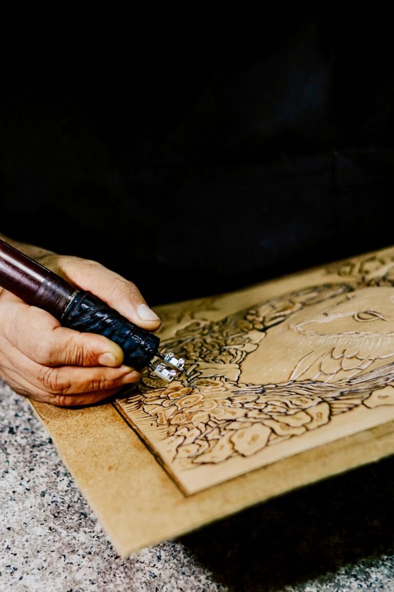 An artisan engraving a monogram into leather with a precision tool