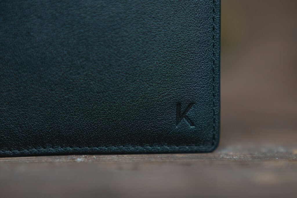 Black leather bifold wallet resting on a white table