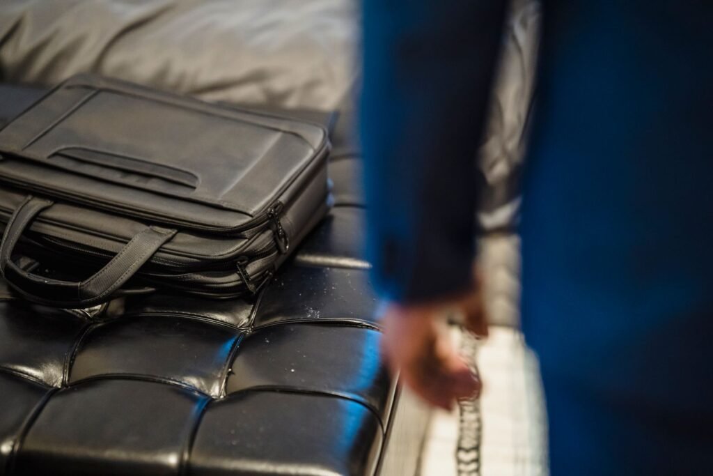 Close-up of a black leather briefcase on a modern couch