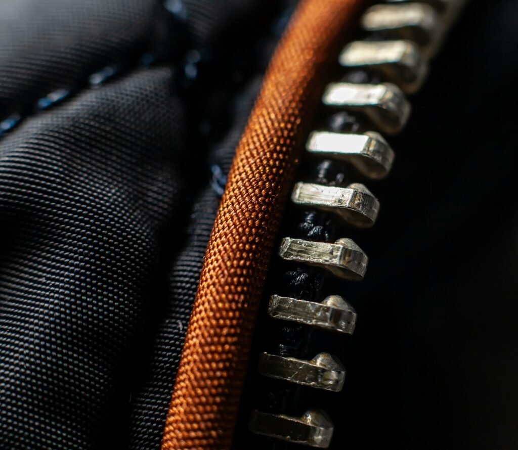 Close-up of a black and orange zippered zipper pull