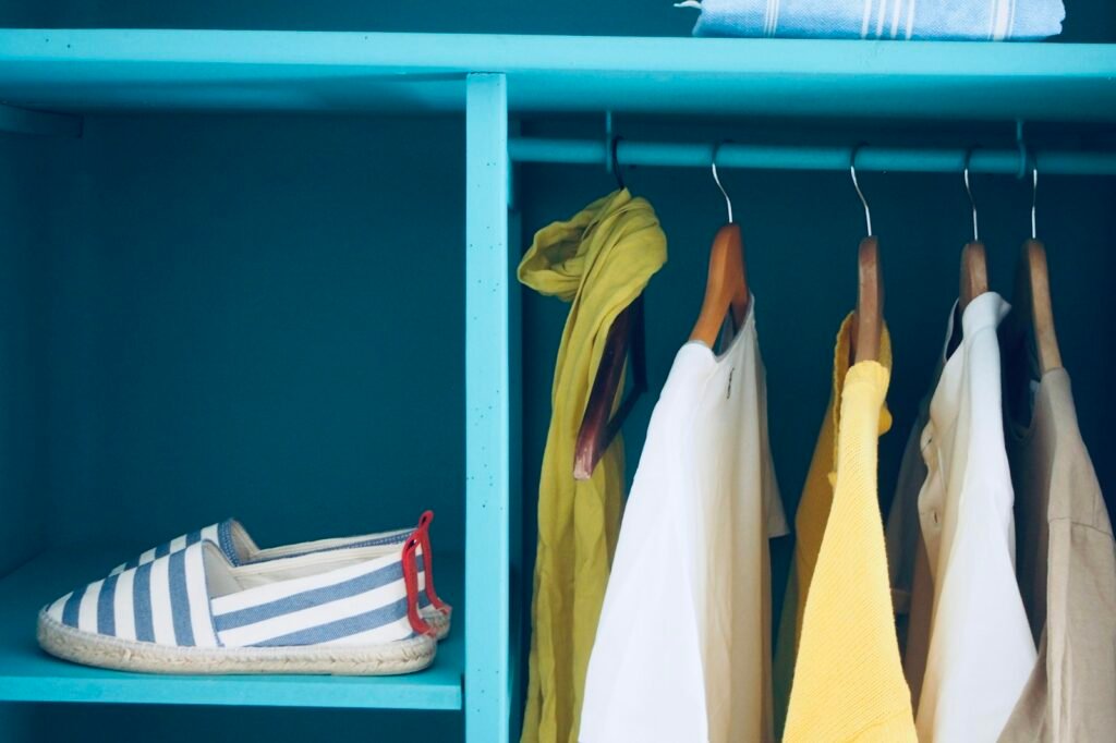 Blue shelf with a pair of shoes and neatly organized clothes
