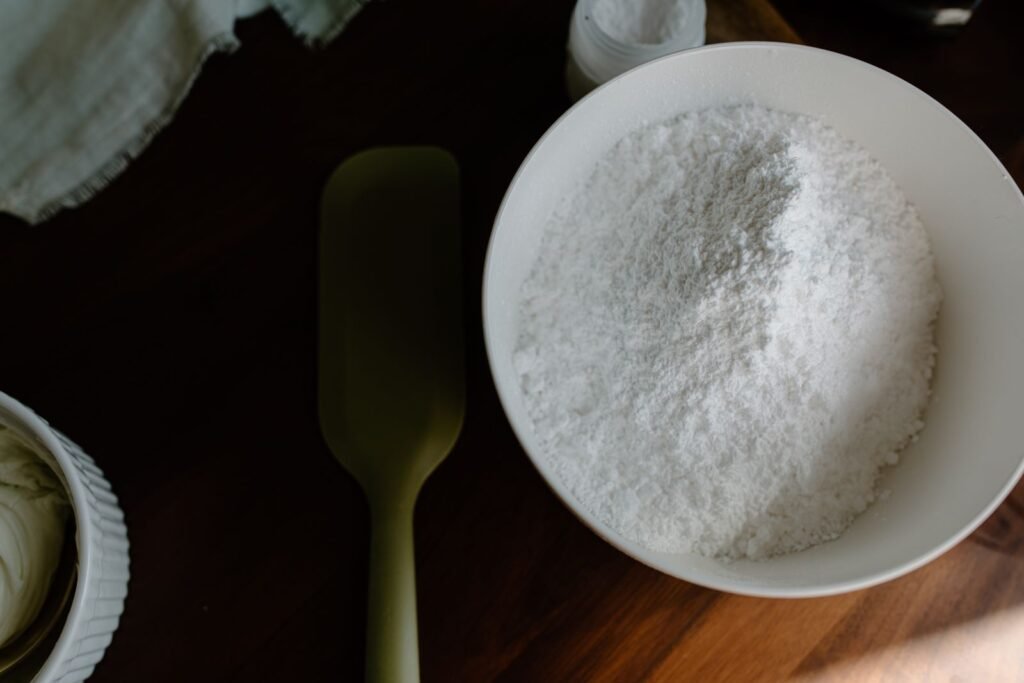 Bowl of fine white powder with baking utensils, similar to cornstarch used to absorb oil stains