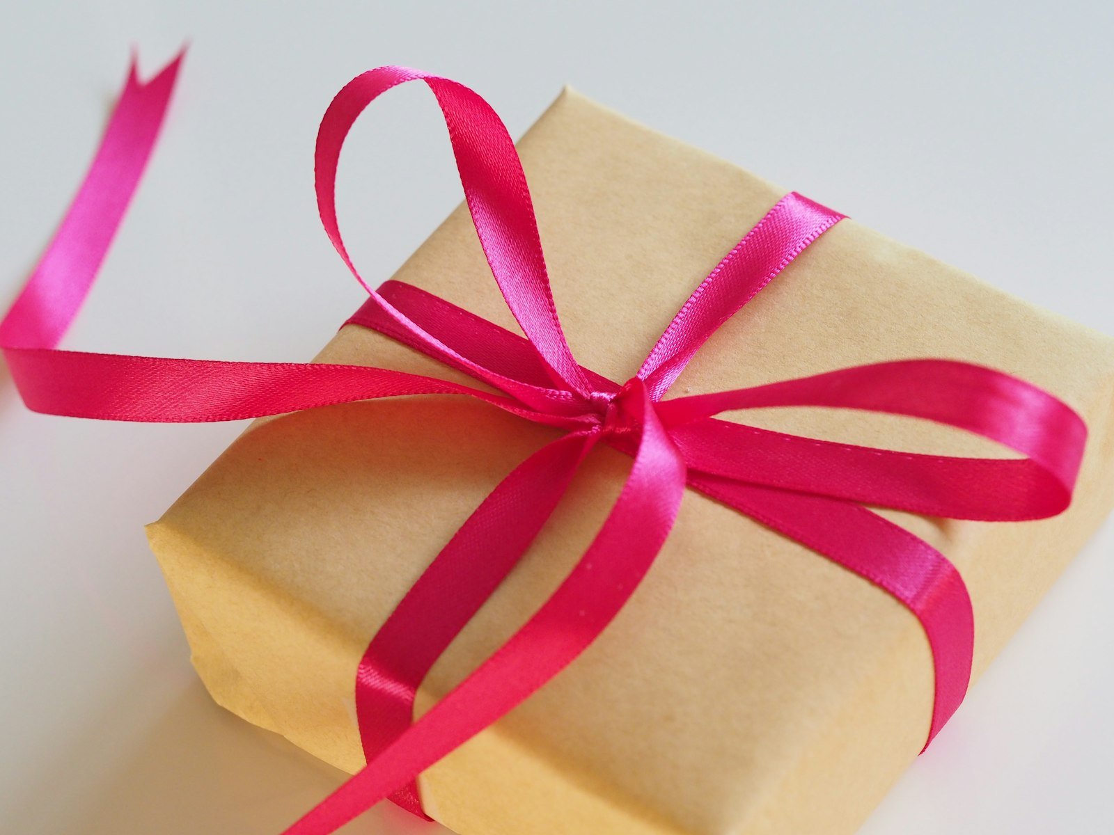 Brown gift box tied with a pink ribbon