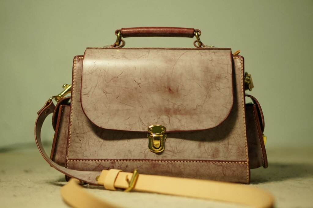 Brown leather bag resting on a table, showing a deconstructed unlined silhouette