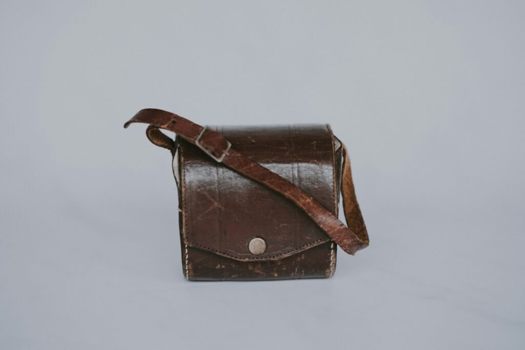 Brown leather crossbody bag showing signs of regular use