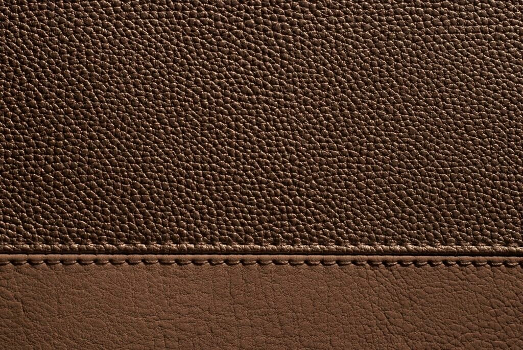 Brown leather with visible stitching creating a textural detail