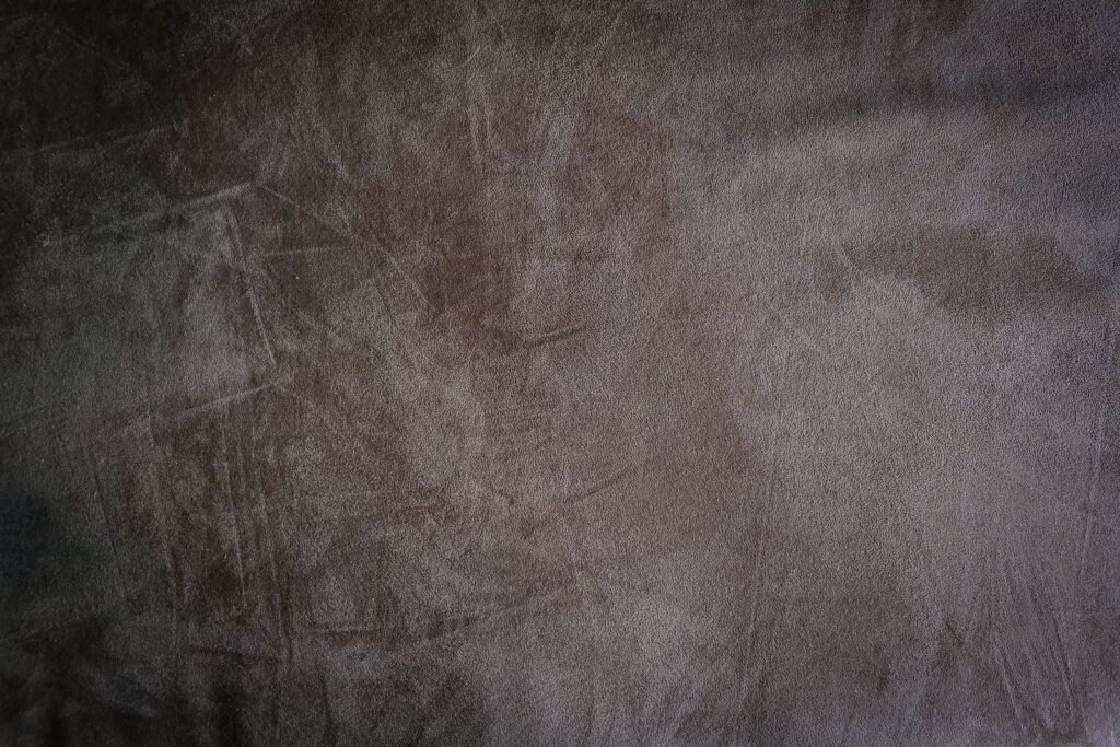 Close-up of brown suede fabric showing its soft napped texture