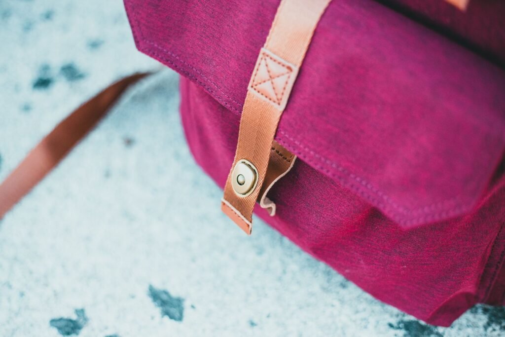Detailed view of a burgundy leather bag featuring leather straps