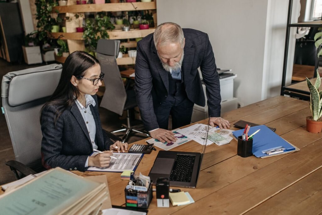 Business professionals having a discussion at an office desk