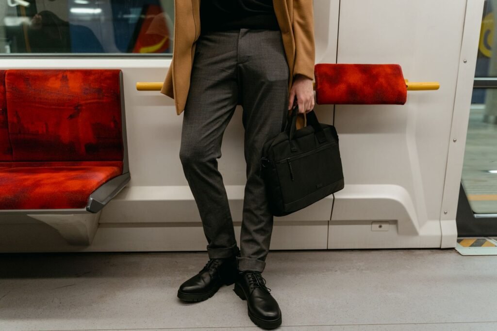 Businessman standing in a train holding a briefcase