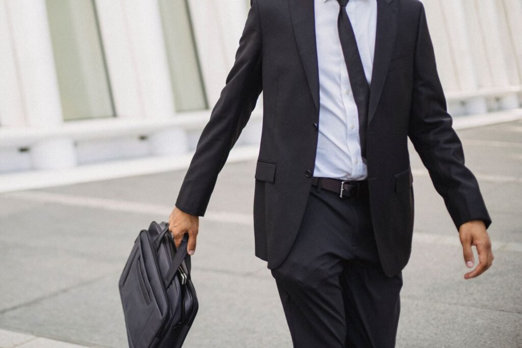 Businessman in a suit carrying a briefcase walking confidently