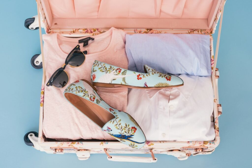 Clothing items and a pair of shoes neatly organized in luggage