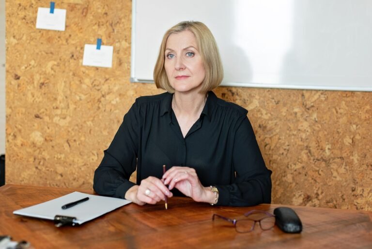 Confident mature businesswoman seated at her desk in an office environment