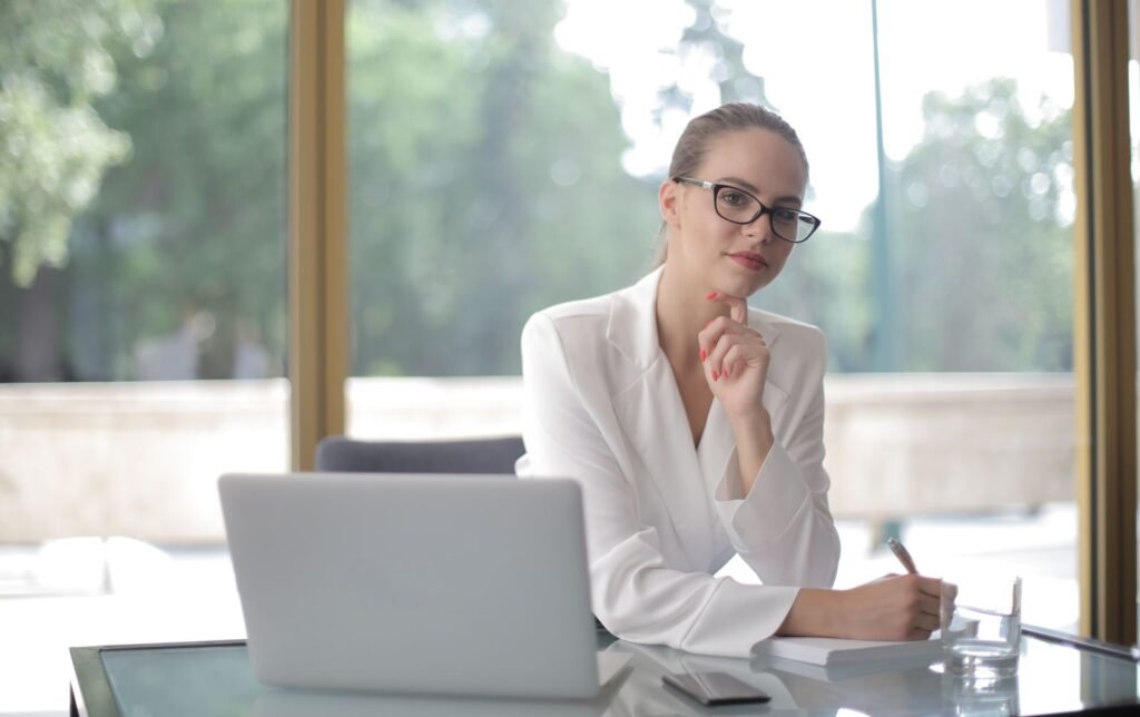 Confident woman in glasses working at a desk