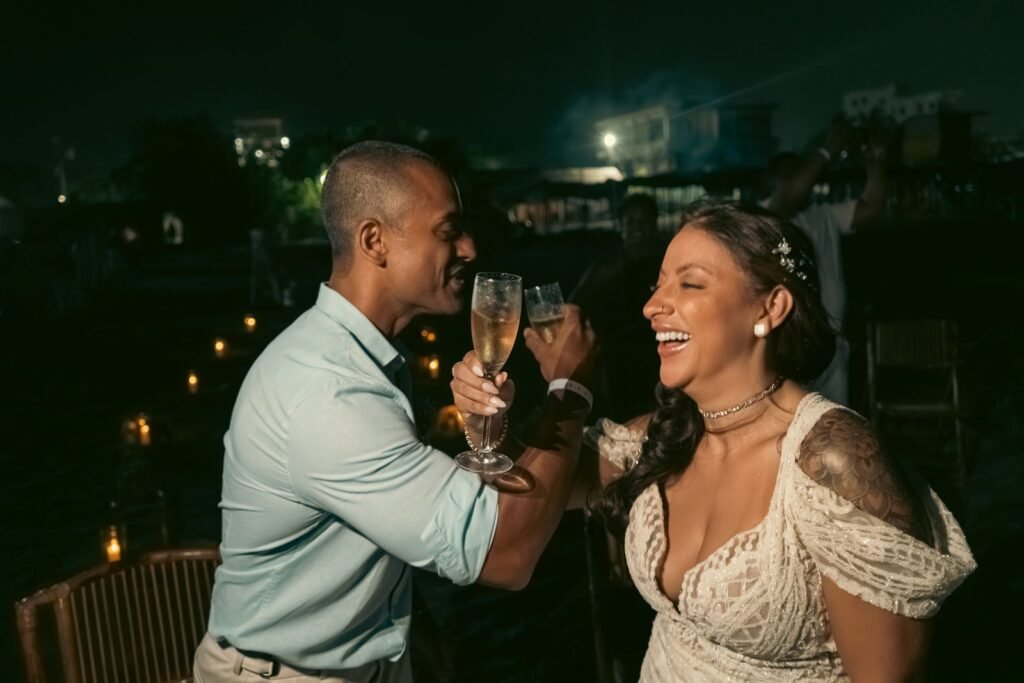 Joyful couple celebrating with a champagne toast at night