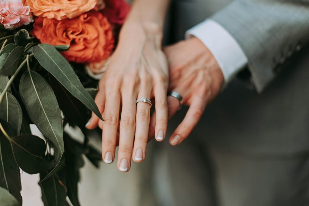 Couple wearing silver-colored wedding rings