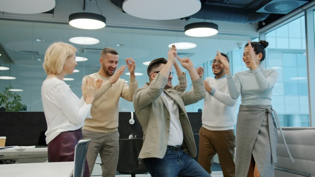 Diverse group of coworkers celebrating a colleague's retirement send-off in the office