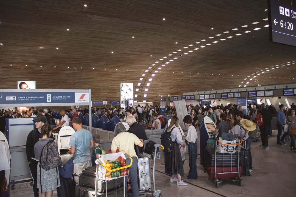 Crowded airport terminal with travellers waiting in line