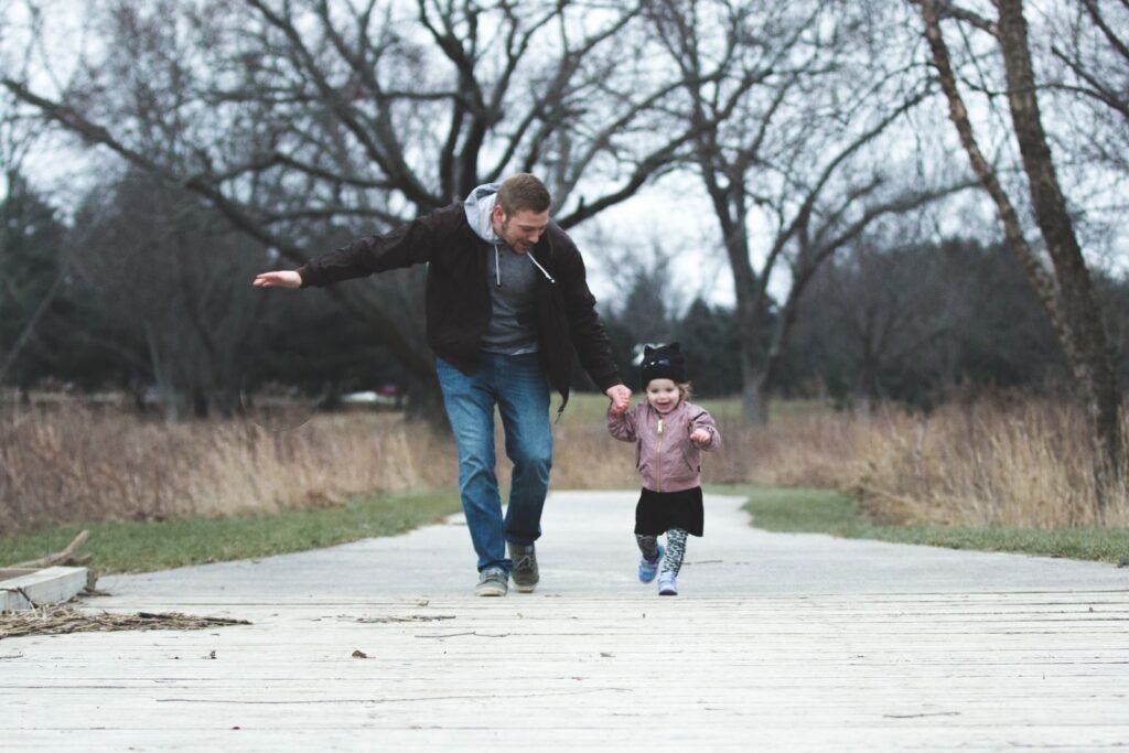 Dad and daughter enjoying a walk together in the park