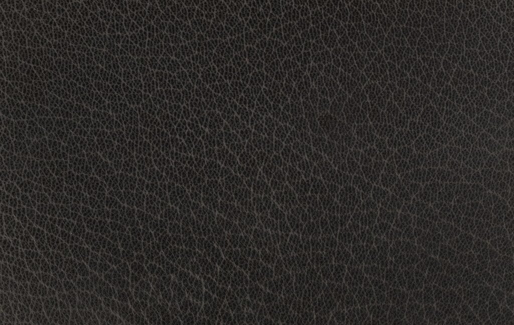 Dark brown textured leather surface close-up