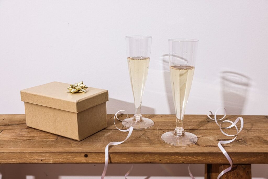 Elegant wooden table setup with champagne glasses and a gift