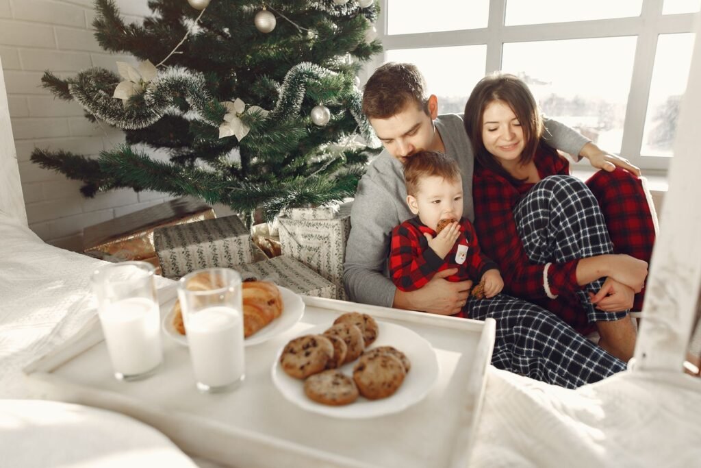 Family enjoying cookies and milk by the Christmas tree