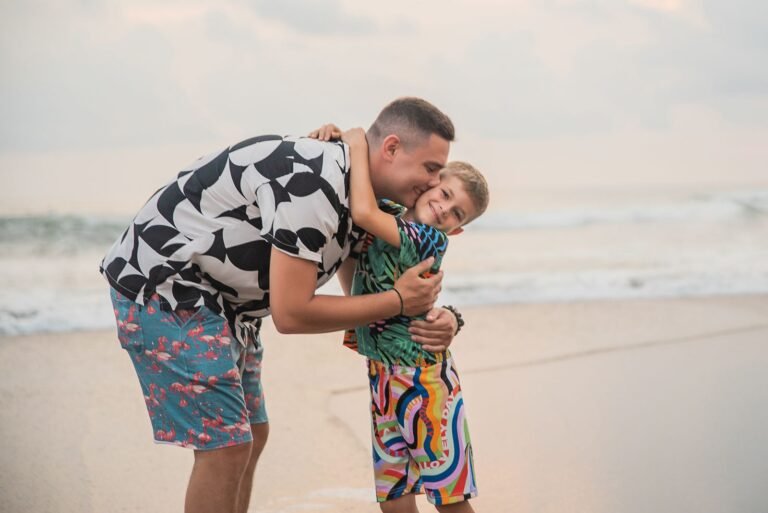 Father and son sharing a heartwarming embrace on a sandy beach