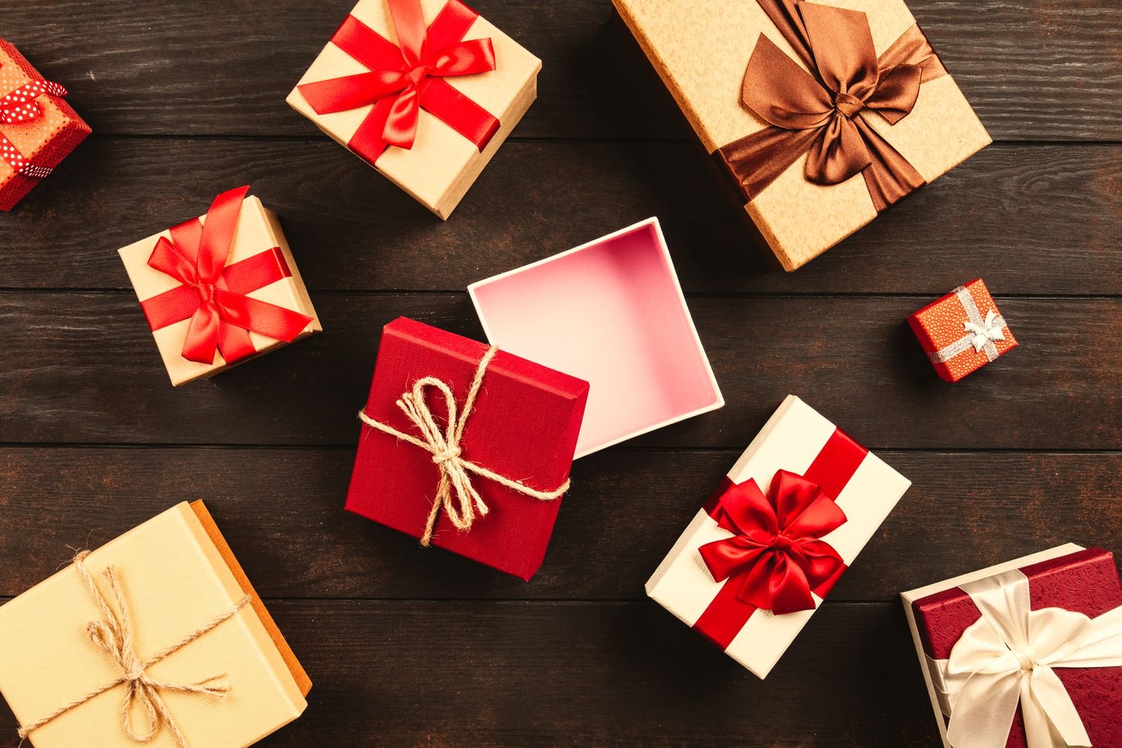 Festive flat lay of various wrapped presents with ribbons