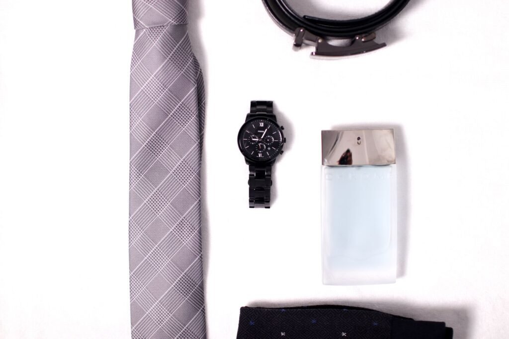 Flat lay of sophisticated men's accessories including a necktie