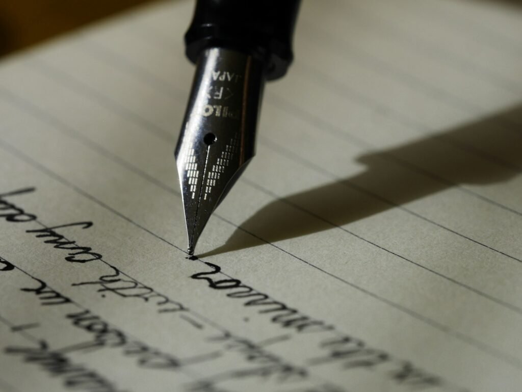 Fountain pen resting on black lined paper