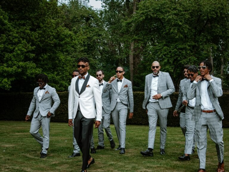 Group of groomsmen standing together in suits at a wedding