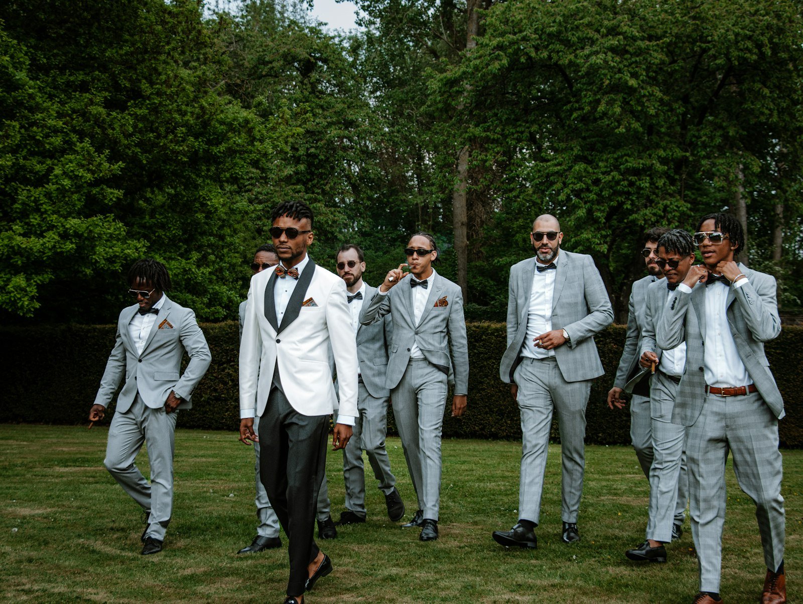 Group of groomsmen standing together in suits at a wedding