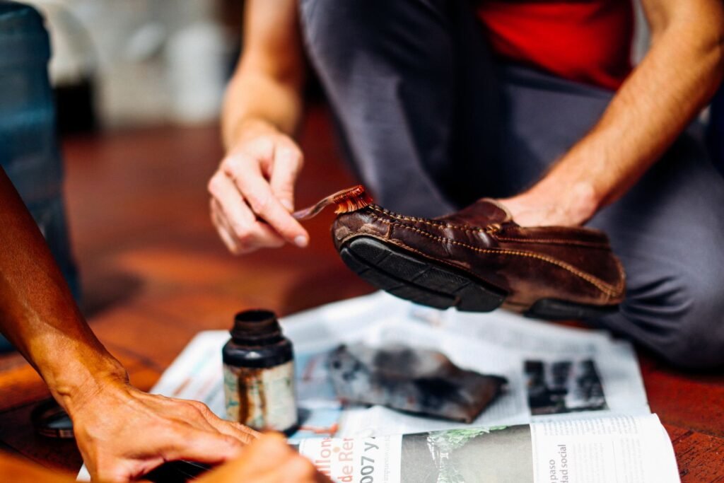 Close-up of hands skillfully polishing a leather shoe