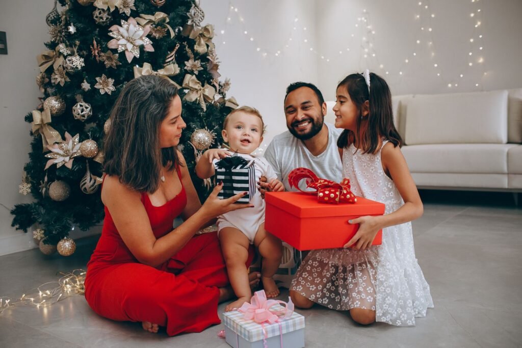 Happy family exchanging gifts around a beautifully decorated Christmas tree