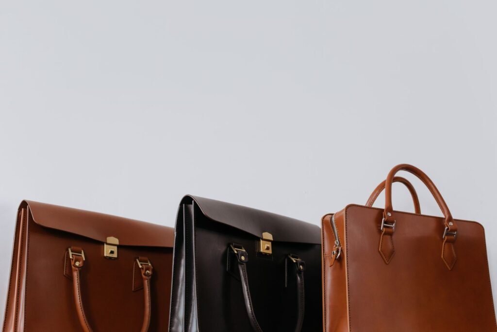 Three elegant full-grain leather briefcases showing rich Horween leather tones