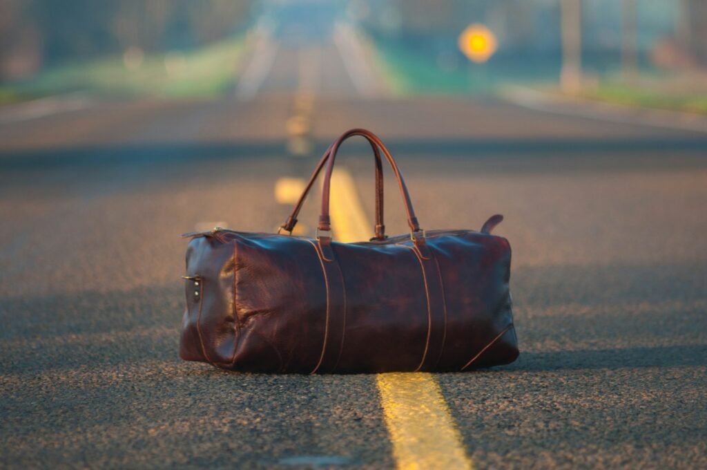 Leather bag resting on pavement, illustrating everyday tote-style carry