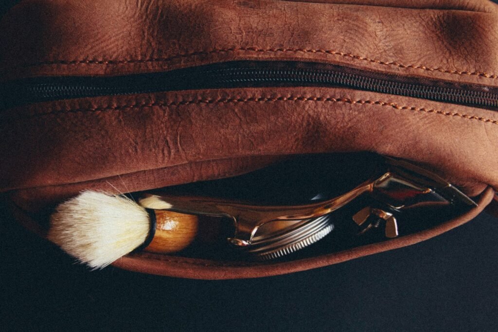 Leather Dopp kit with shaving brush and razor packed for travel
