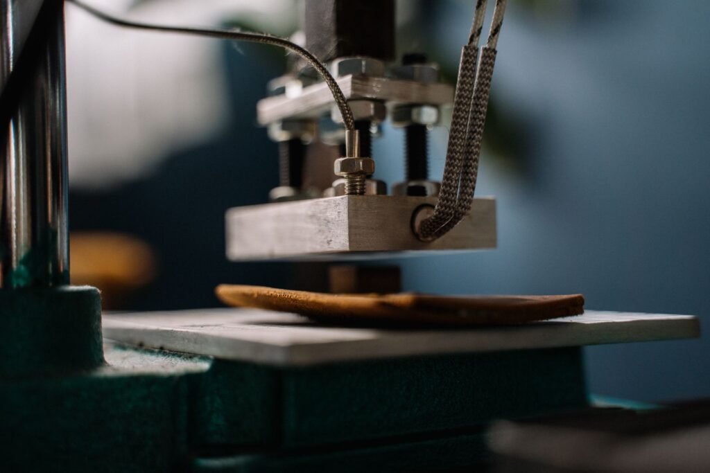 Detailed view of a leather embossing machine pressing leather