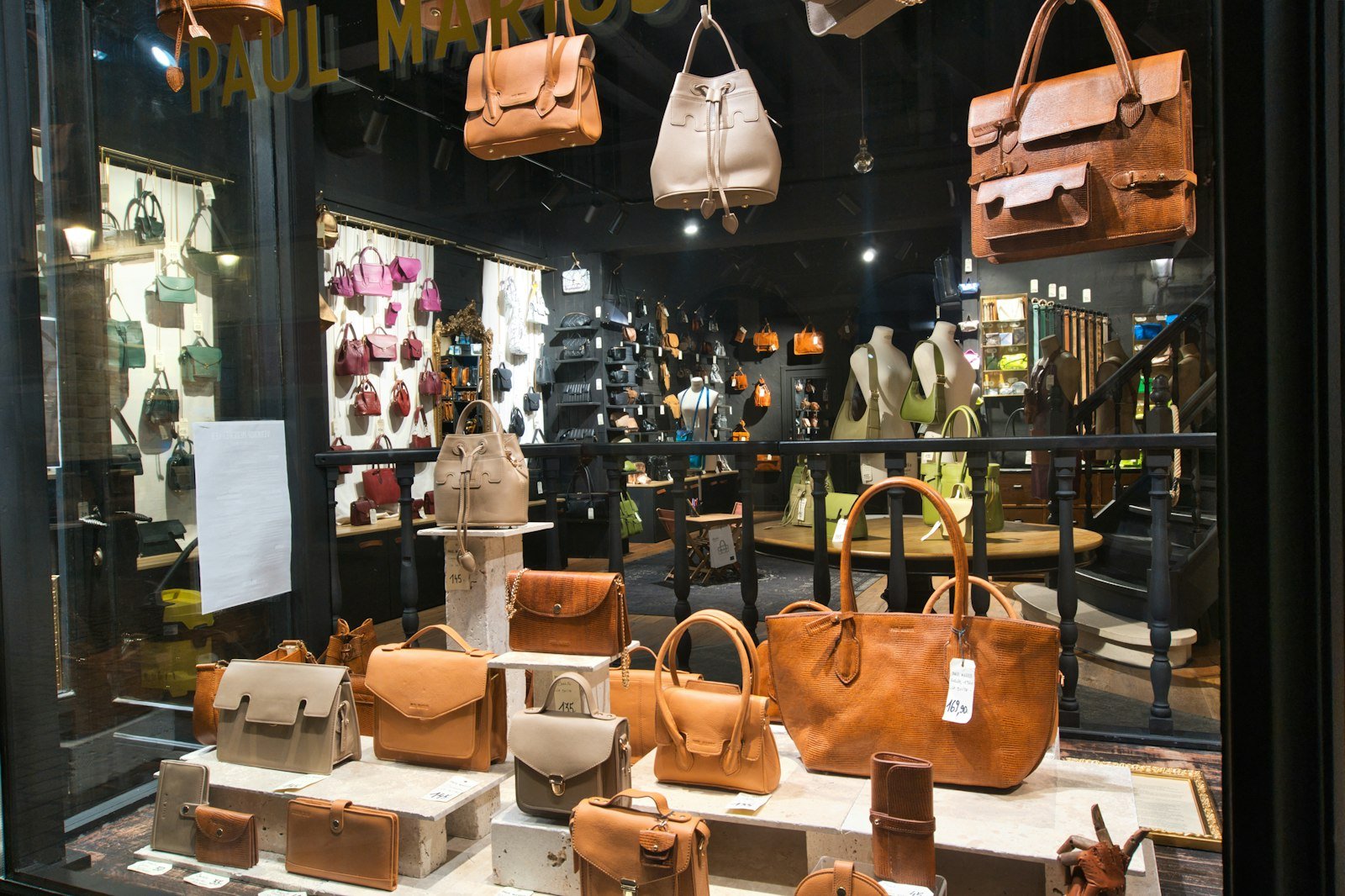 Leather handbags displayed in a retail store window