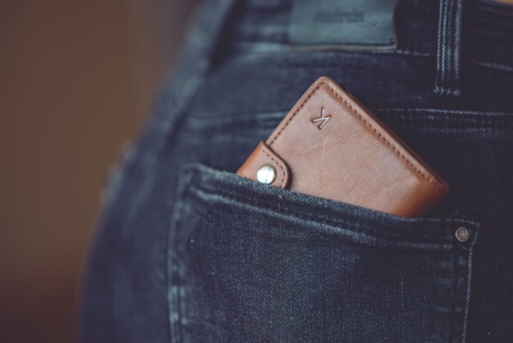 Leather wallet carried daily in a jeans pocket, developing patina through use