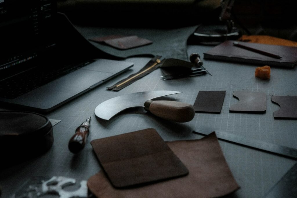 A table topped with a variety of leathercraft tools