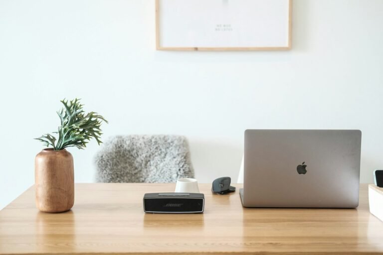 MacBook Pro resting on a brown wooden desk workspace