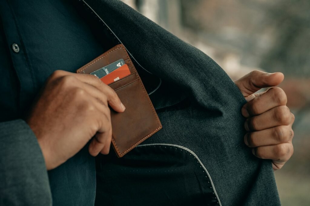 Man holding a wallet near his back pocket, illustrating everyday carry comfort
