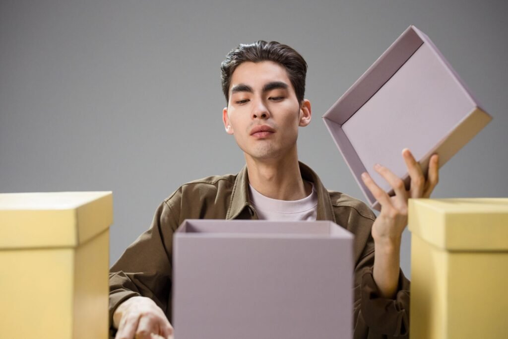 Man opening a gift box with a curious expression