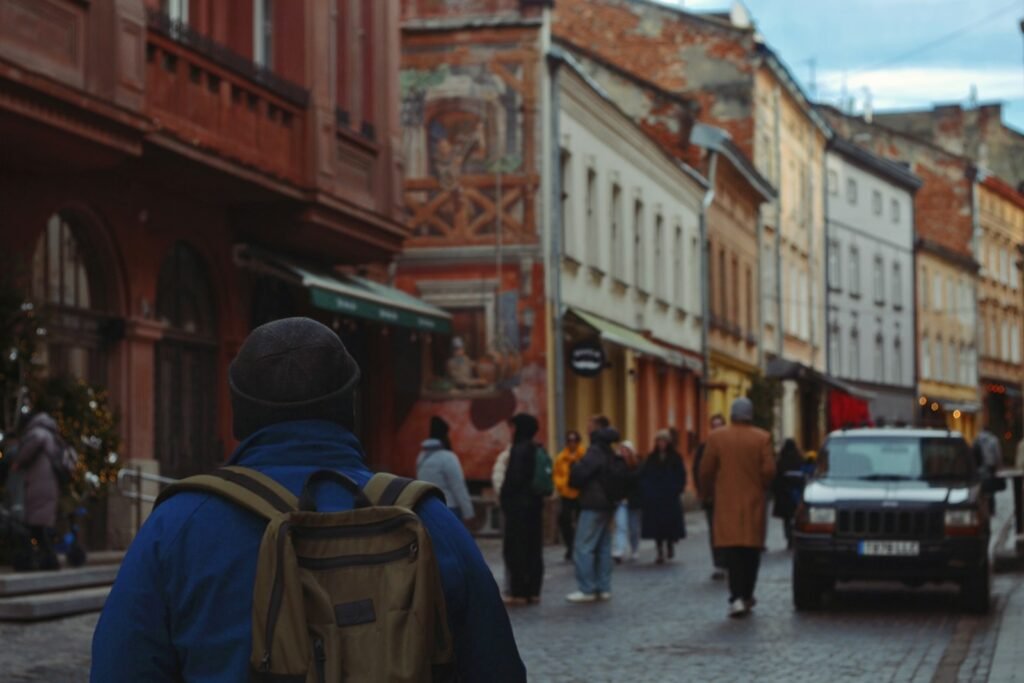 Man walking on a European street lined with historic architecture