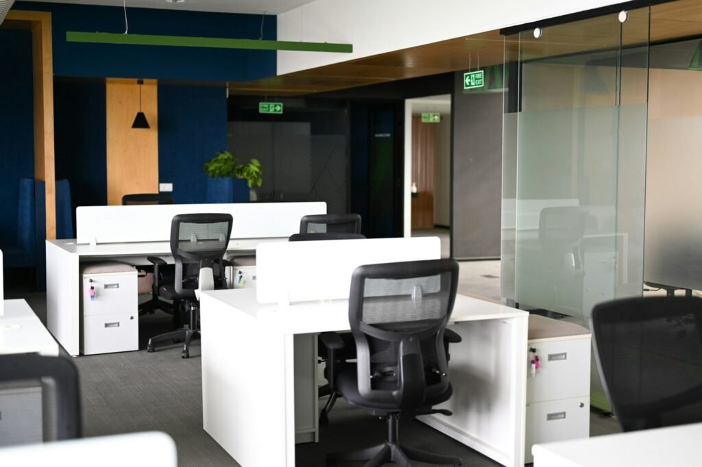 Modern office interior with white desks and black chairs