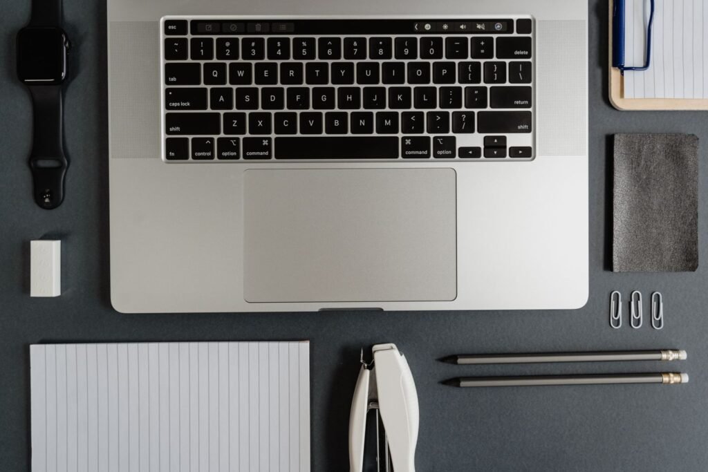 Top-down view of a neatly arranged office desk featuring a laptop
