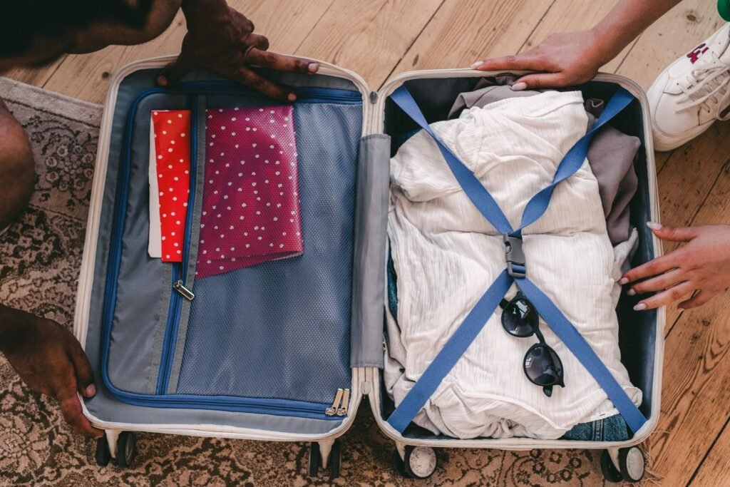 A neatly packed open suitcase with clothing and travel essentials